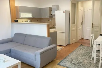 a living room with a couch and a kitchen at Spacious place on Metro station Andel in Prague