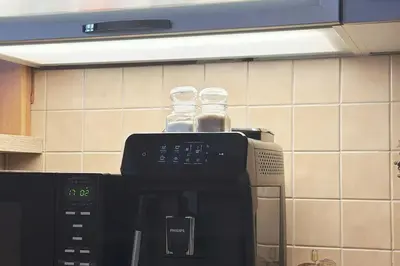 two glass bottles sitting on top of a microwave at Spacious place on Metro station Andel in Prague