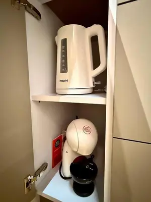 a kitchen cupboard with a toaster and a blender at NEW IOS Velour in Prague