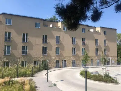 a large brick building with a circular driveway at Cozy Apartment Prague Airport- 5 minute drive from AirPort in Tuchoměřice