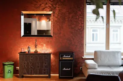 a balcony with a couch and a table and a window at Gentleman Spirit Residence Prague in Prague