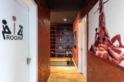 a hallway with a room with legs on the wall at Gentleman Spirit Residence Prague in Prague