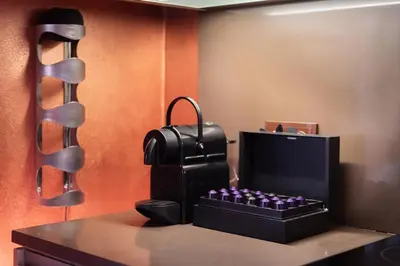 a desk with a black suitcase and a knife at Gentleman Spirit Residence Prague in Prague