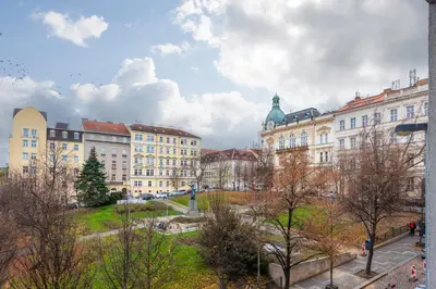 a group of buildings in a city with trees at Gentleman Spirit Residence Prague in Prague
