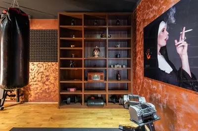 a living room with a large book shelf at Gentleman Spirit Residence Prague in Prague
