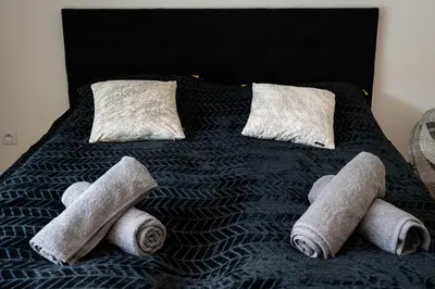 a bed with some rolled up towels on it at Brand Deluxe Suite in Prague