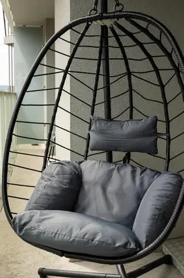 a black swing chair with a pillow in a room at Brand Deluxe Suite in Prague