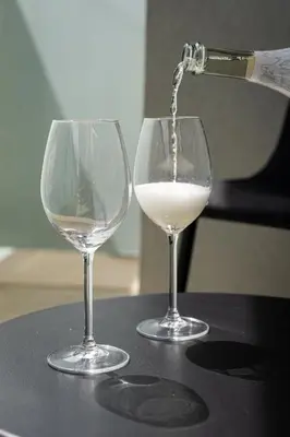 two glasses of white wine are being poured at Brand Deluxe Suite in Prague