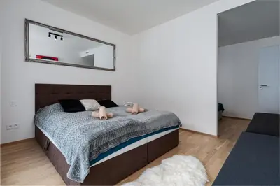 a bedroom with a bed with a mirror on the wall at Brand Deluxe Suite in Prague