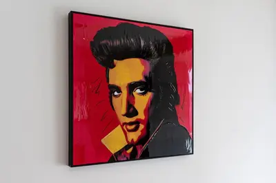 a painting of a man on a red background at Brand Deluxe Suite in Prague