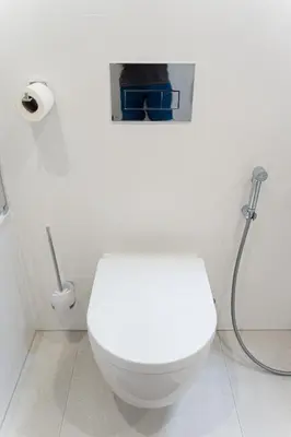a bathroom with a white toilet with a shower at Brand Deluxe Suite in Prague