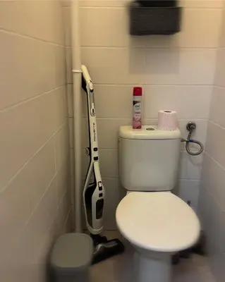 a toilet in a bathroom with a vacuum at Downtown Prague in Prague