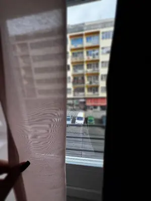 a person reading a book in front of a window at Downtown Prague in Prague