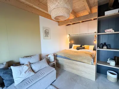 a bedroom with a bed and a couch at Chalet Slapy in Slapy