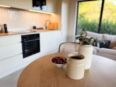 a table with a cup of coffee and a bowl of cherries at Chalet Slapy in Slapy
