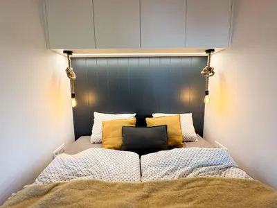 a bed with yellow pillows on top of it at Chalet Slapy in Slapy