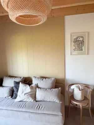 a living room with a couch and a chandelier at Chalet Slapy in Slapy