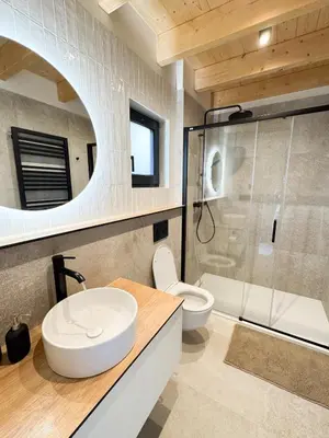 a bathroom with a sink and a toilet and a shower at Chalet Slapy in Slapy