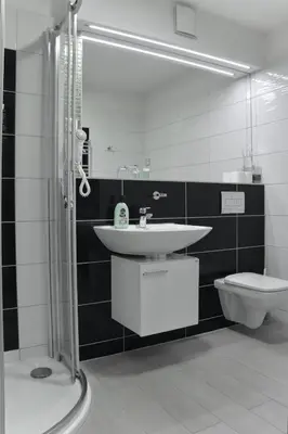 a bathroom with a sink and a toilet at Royal Villas in Prague