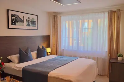 a bedroom with a large bed and a window at Royal Villas in Prague