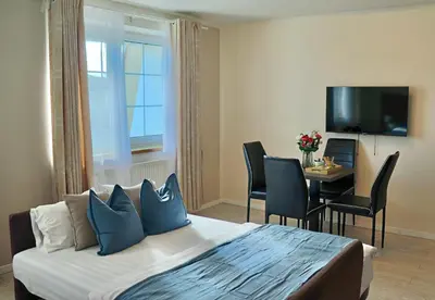 a hotel room with a bed and a table with chairs at Royal Villas in Prague