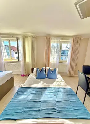 a bedroom with a large bed with blue pillows at Royal Villas in Prague