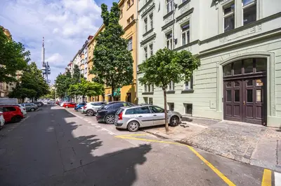 a street with cars parked on the side of the road at Apartments Ripska in Prague