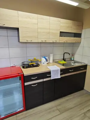a kitchen with wooden cabinets and a counter top at Apartmány Zámecká in Roudnice nad Labem