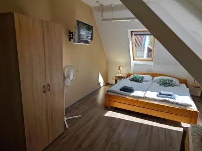 a bedroom with a bed in a attic at Apartmány Zámecká in Roudnice nad Labem