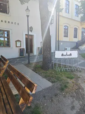 a group of benches in front of a building at Apartmány Zámecká in Roudnice nad Labem