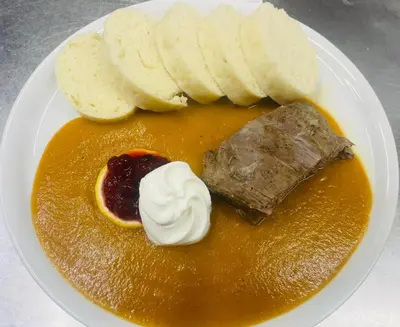 a plate of food with bread and dessert on it at Apartmány Zámecká in Roudnice nad Labem