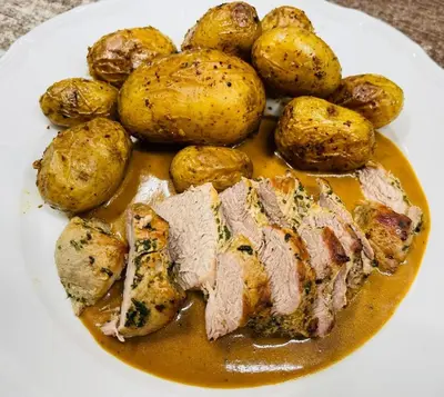 a plate of food with meat and potatoes on it at Apartmány Zámecká in Roudnice nad Labem