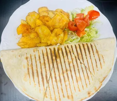 a plate of food with chicken and vegetables on it at Apartmány Zámecká in Roudnice nad Labem