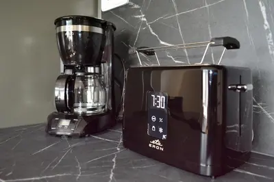a blender sitting next to a microwave on a counter at Newly renovated house near Prague in Nové Jirny