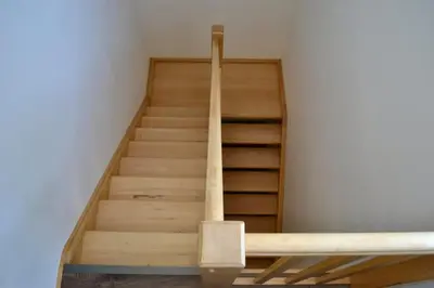 a staircase in a room with wooden steps at Newly renovated house near Prague in Nové Jirny