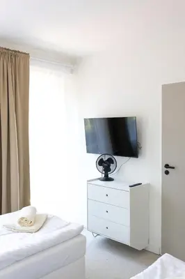 a black shelf with glasses on a wall at Hotel Sport Houštka