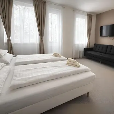 a bedroom with a large white bed with a yellow chair at Hotel Sport Houštka