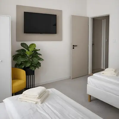a white bed with white sheets and green pillows at Hotel Sport Houštka