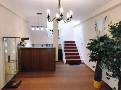 a lobby with a staircase and a chandelier at Statek Otradovice hotel