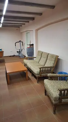 a living room with couches and a table and a gym at Statek Otradovice hotel