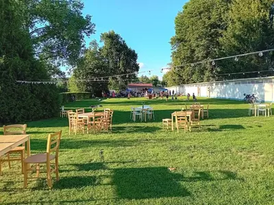 a group of tables and chairs in the grass at Čerčanská Koupadla - glampingové stany in Benešov