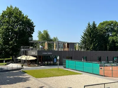 a building with a playground on top of it at Čerčanská Koupadla - glampingové stany in Benešov