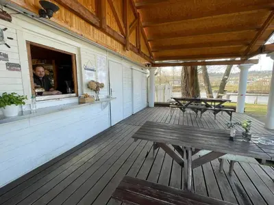 a porch of a building with a table and benches at Čerčanská Koupadla - glampingové stany in Benešov