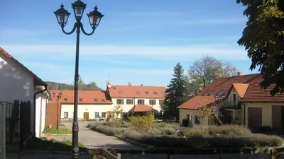 a street light in a village with houses and buildings at Caravan on farm