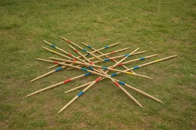 a pile of wooden baseball bats on the grass at Caravan on farm