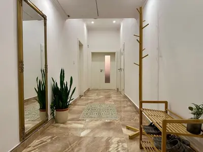 a hallway with a mirror and potted plants at City & River Apartment in Prague