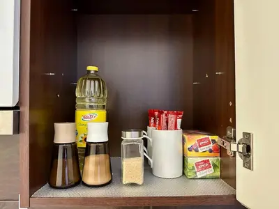 a shelf in a kitchen with condiments at City & River Apartment in Prague