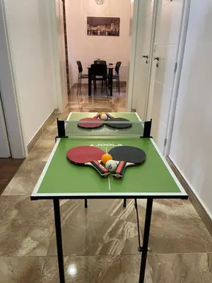 two tables with ping pong balls on top of them at City & River Apartment in Prague