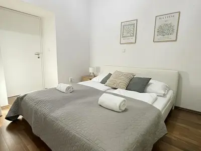a bedroom with a large bed with two towels on it at City & River Apartment in Prague
