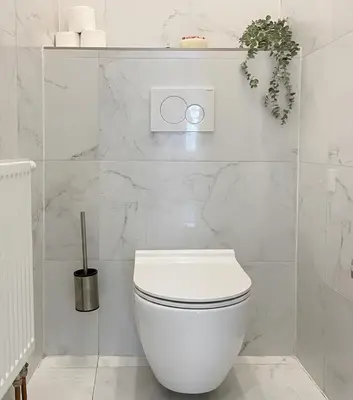 a white bathroom with a white toilet in it at City & River Apartment in Prague